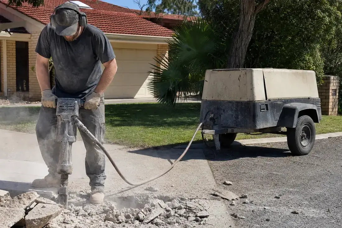 Air compressor hire Perth - towable diesel compressor running an air tool
