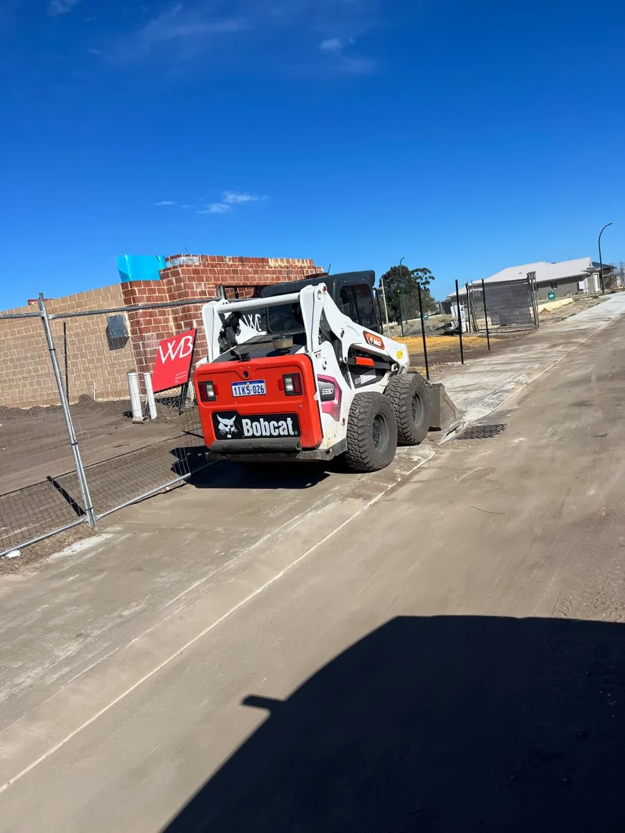 Bobcat skid steer working off the concrete hardstand on a Perth building block