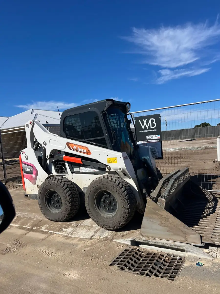 Bobcat skid steer with its bucket down on a Perth residential building site