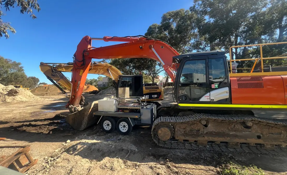 Tracked excavators standing on a Perth earthworks site ready for collection