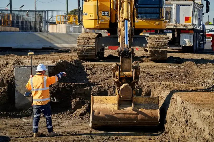 Excavator loading spoil into a tipper truck on a Baldivis earthworks site, Perth