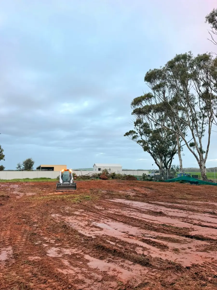 Posi-track Bobcat on a stripped section of block with the vegetation and topsoil removed